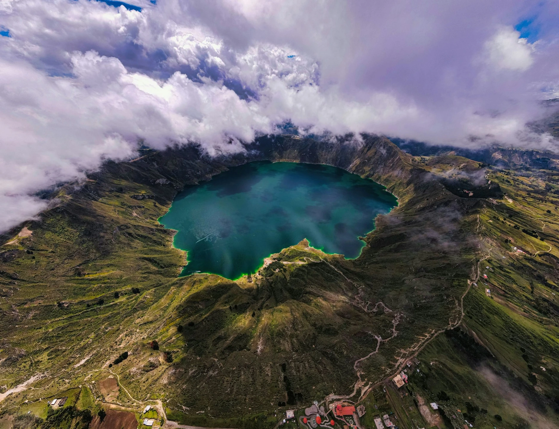 an aerial view of a Quilotoa lake surrounded by mountains